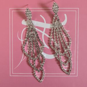 a pair of earrings on a pink background